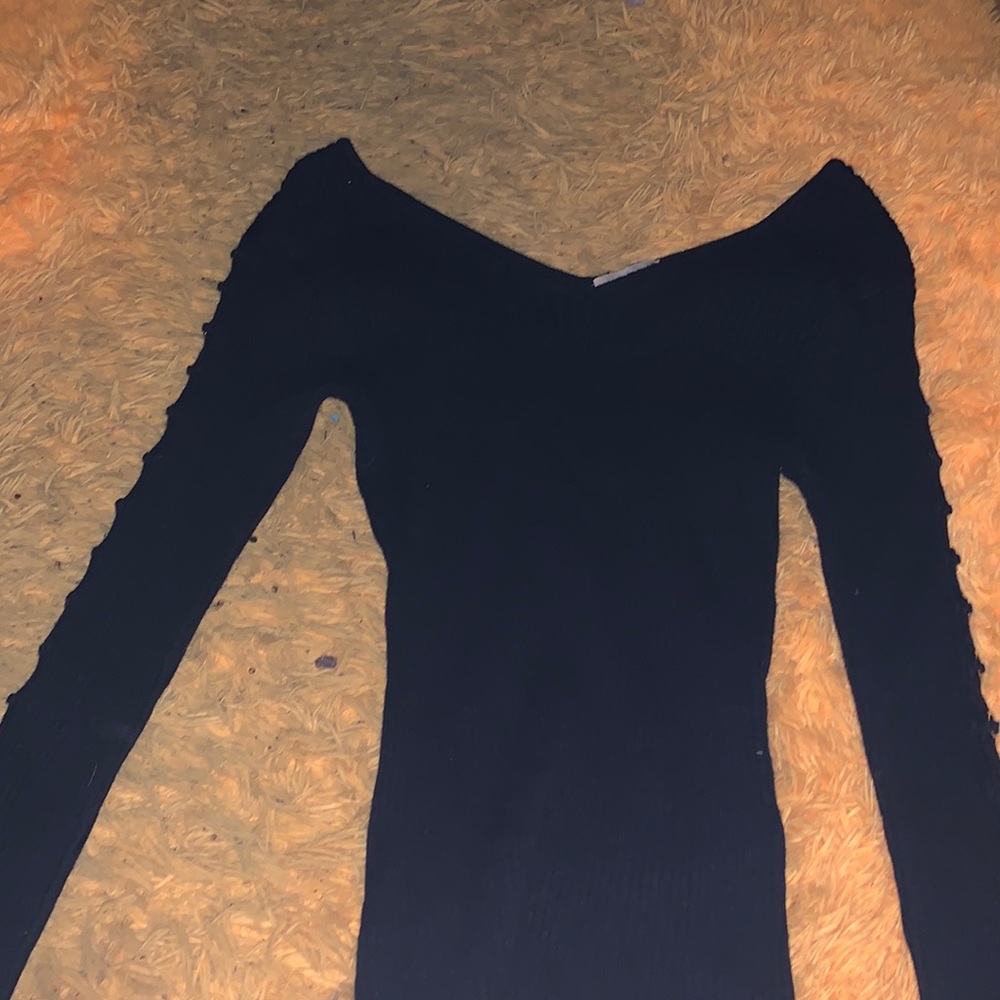 Black long sleeve sweater. With cute design on sides. V neck. Size medium.